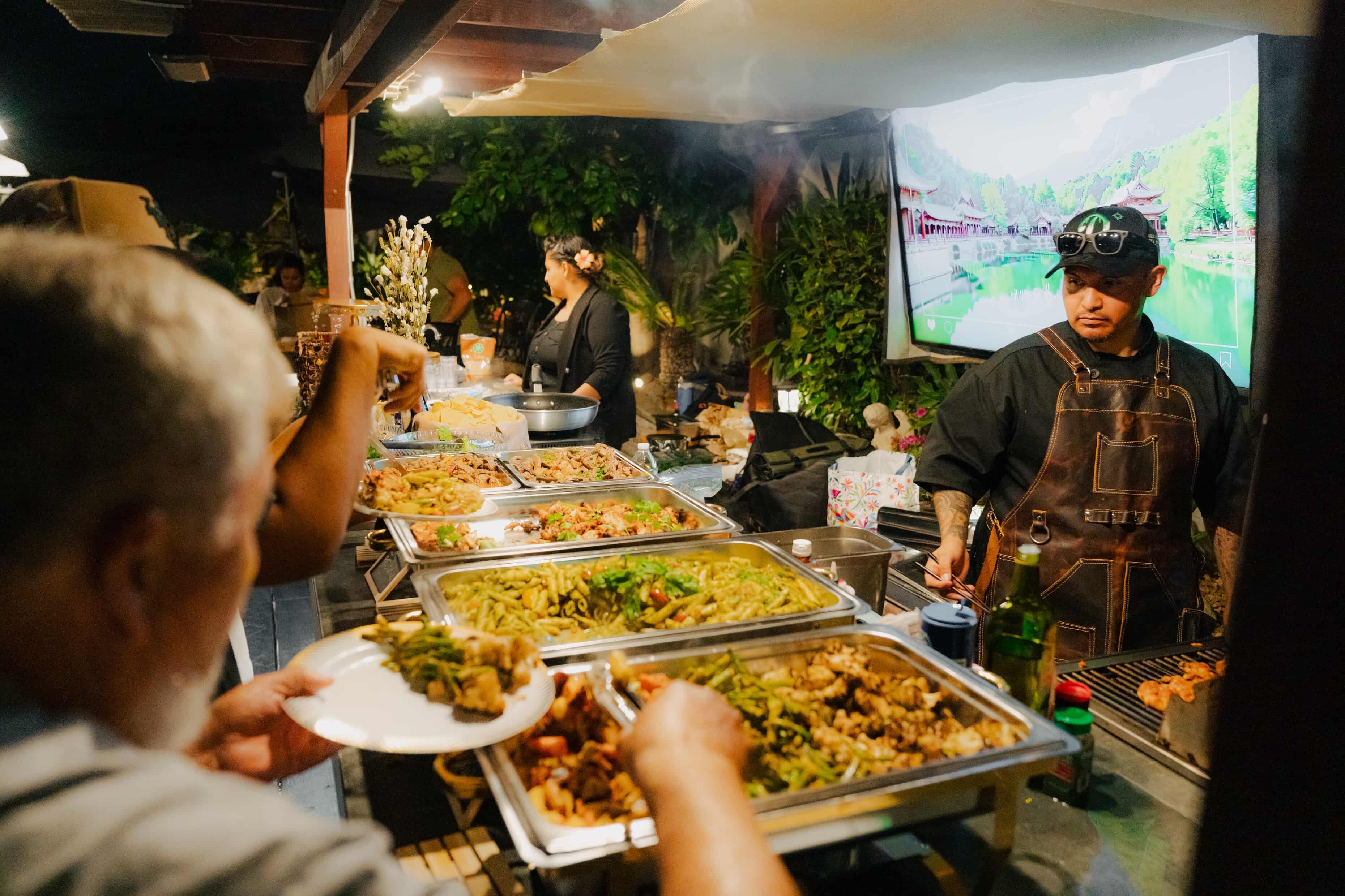 Chef CJ serving guests at a live buffet event