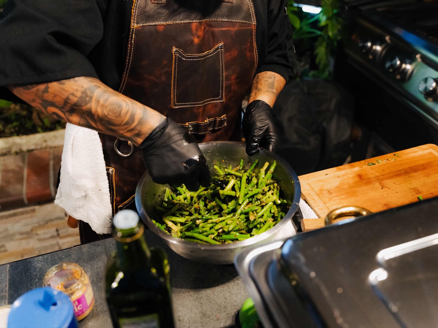 Chef CJ preparing seasoned vegetables during a live event