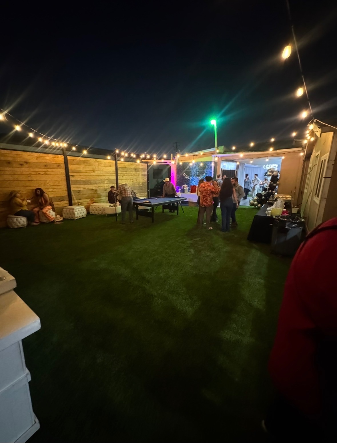 LaBodega outdoor venue at night with string lights and guests