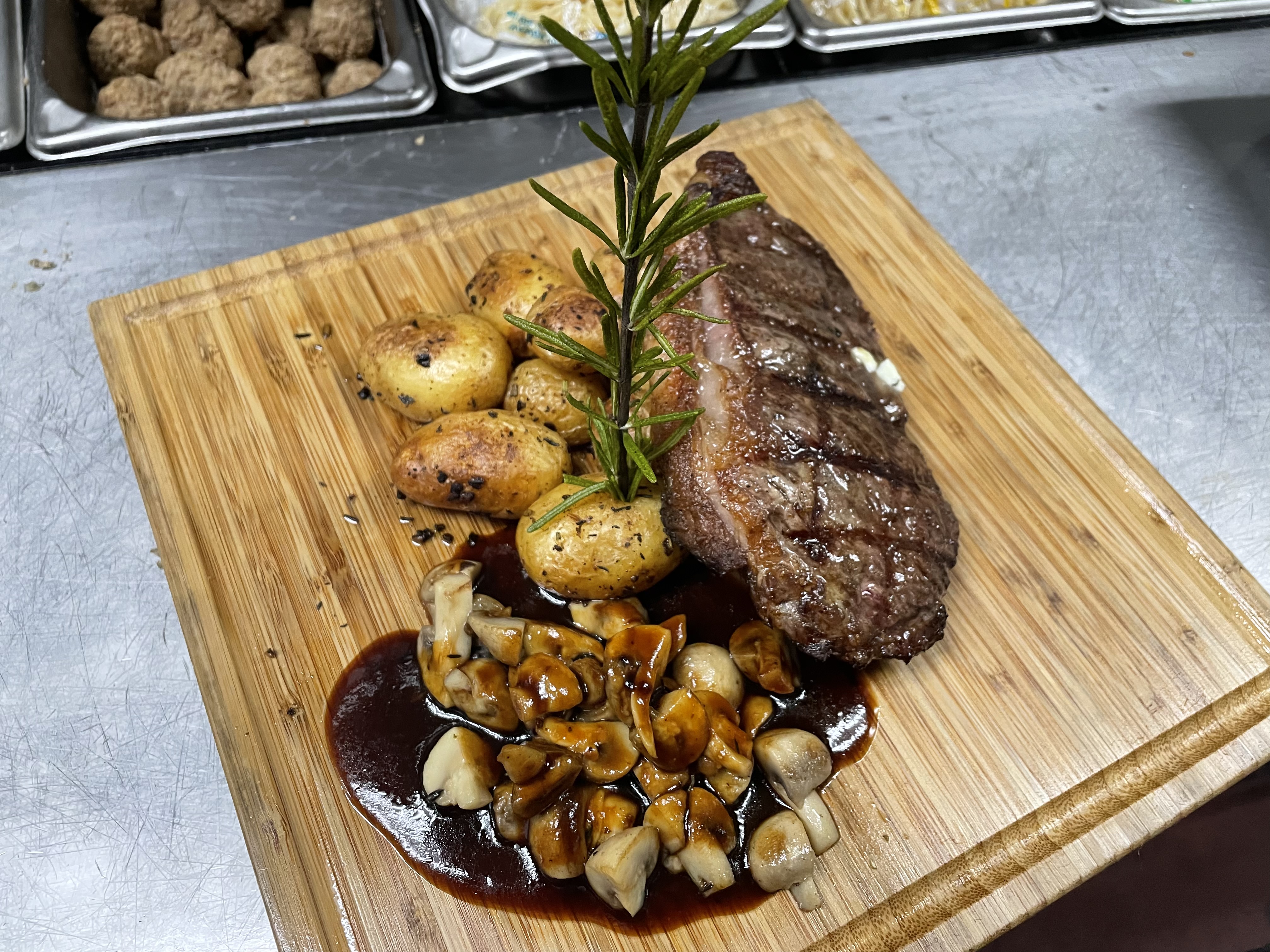 Chef CJ's steak dinner with roasted potatoes, mushrooms, rosemary, and sauce